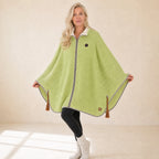 Woman wearing the green Snugloo heated cape with sherpa collar