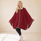 Woman wearing the red Snugloo heated cape with sherpa collar