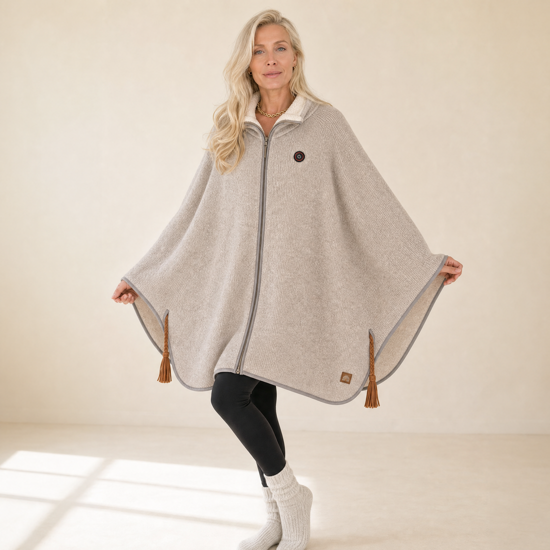 Woman wearing the oatmeal Snugloo heated cape with sherpa collar